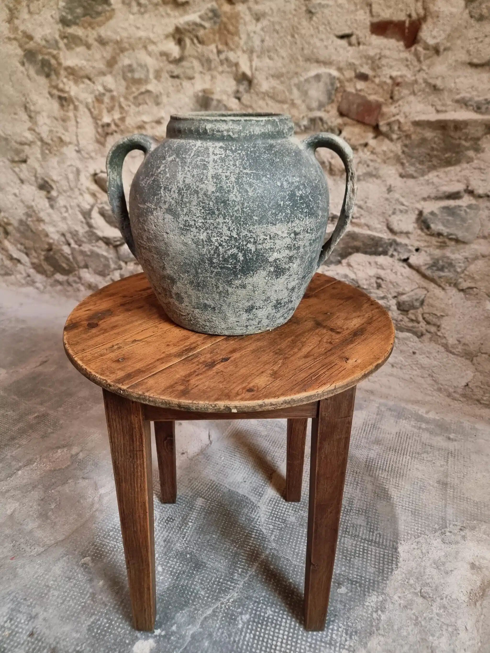 Antique round side table with oak legs and a pine top, circa 1900.