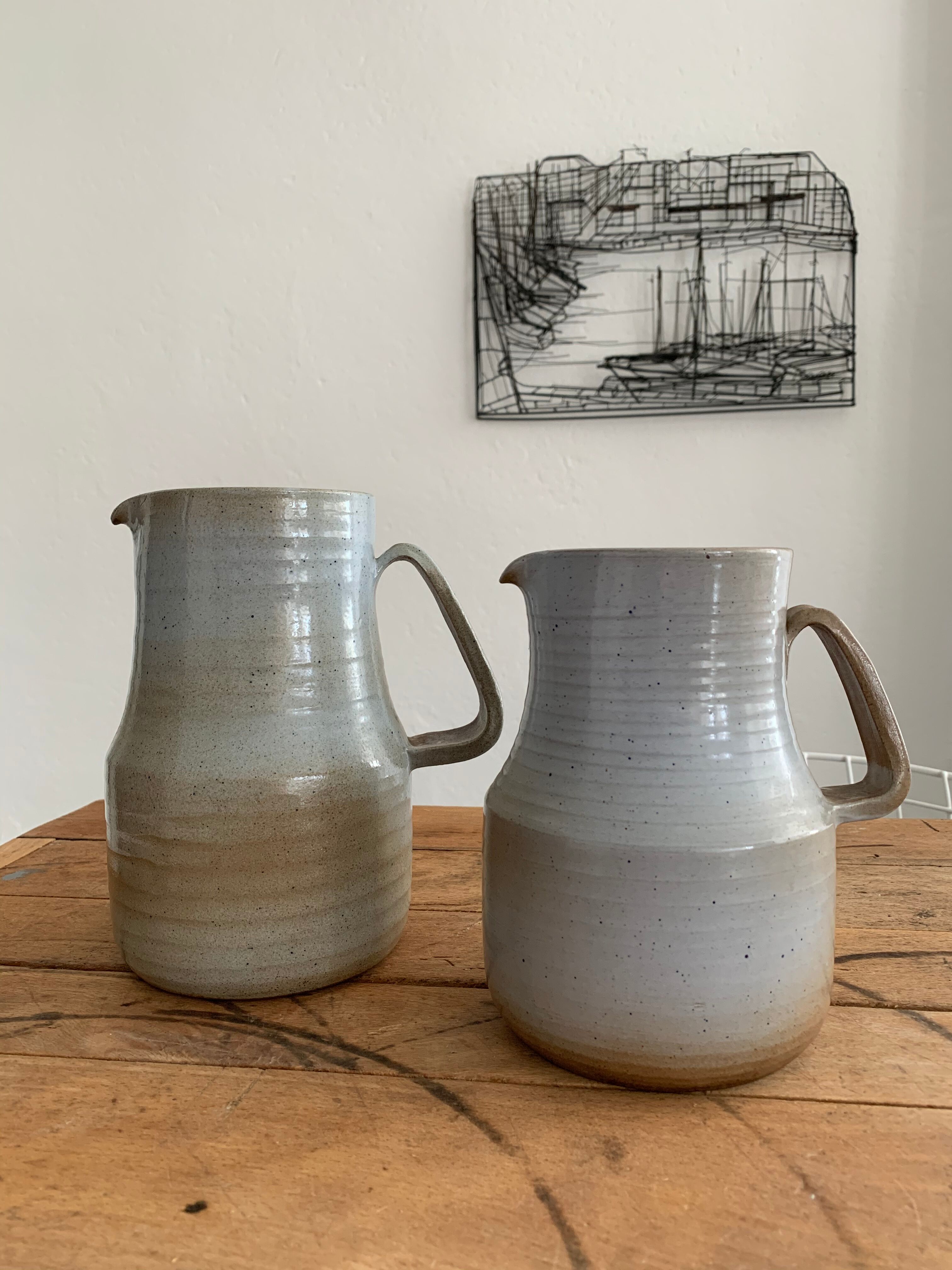 Pair vintage enamelled ceramic pitchers