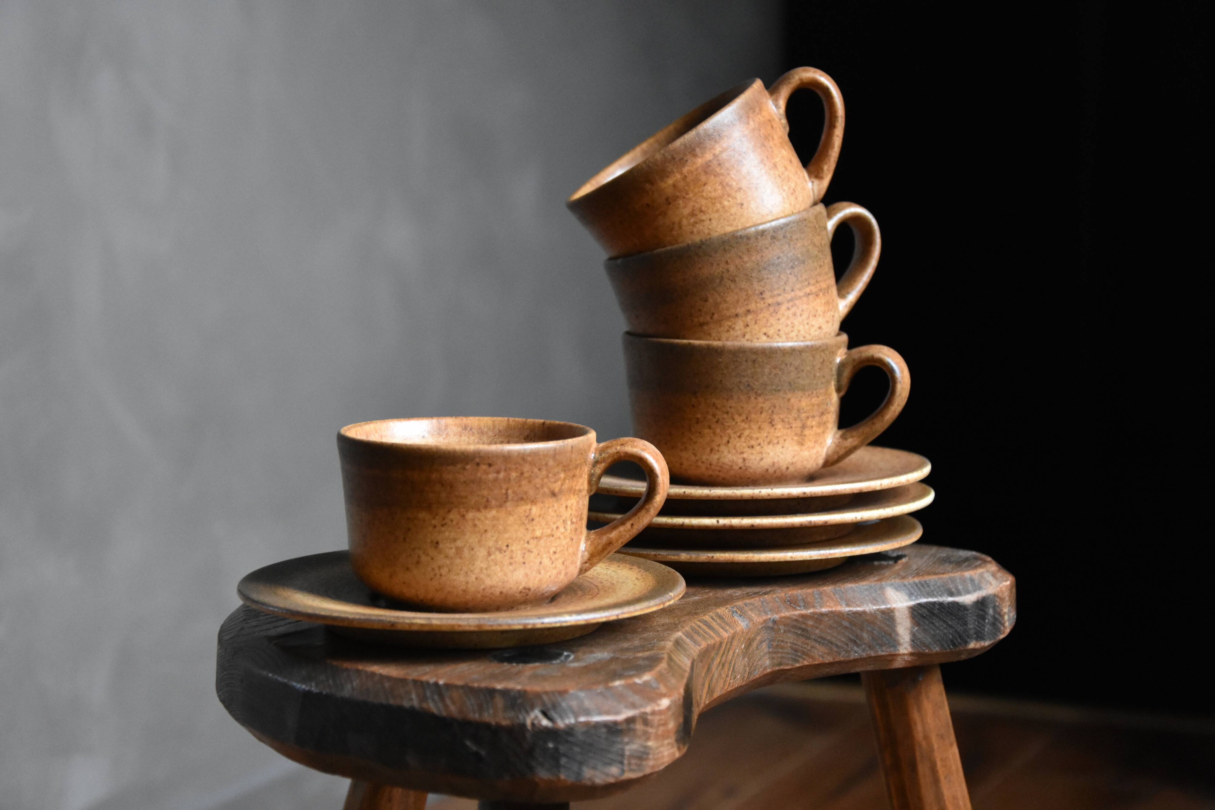 4 sandstone cups and saucers