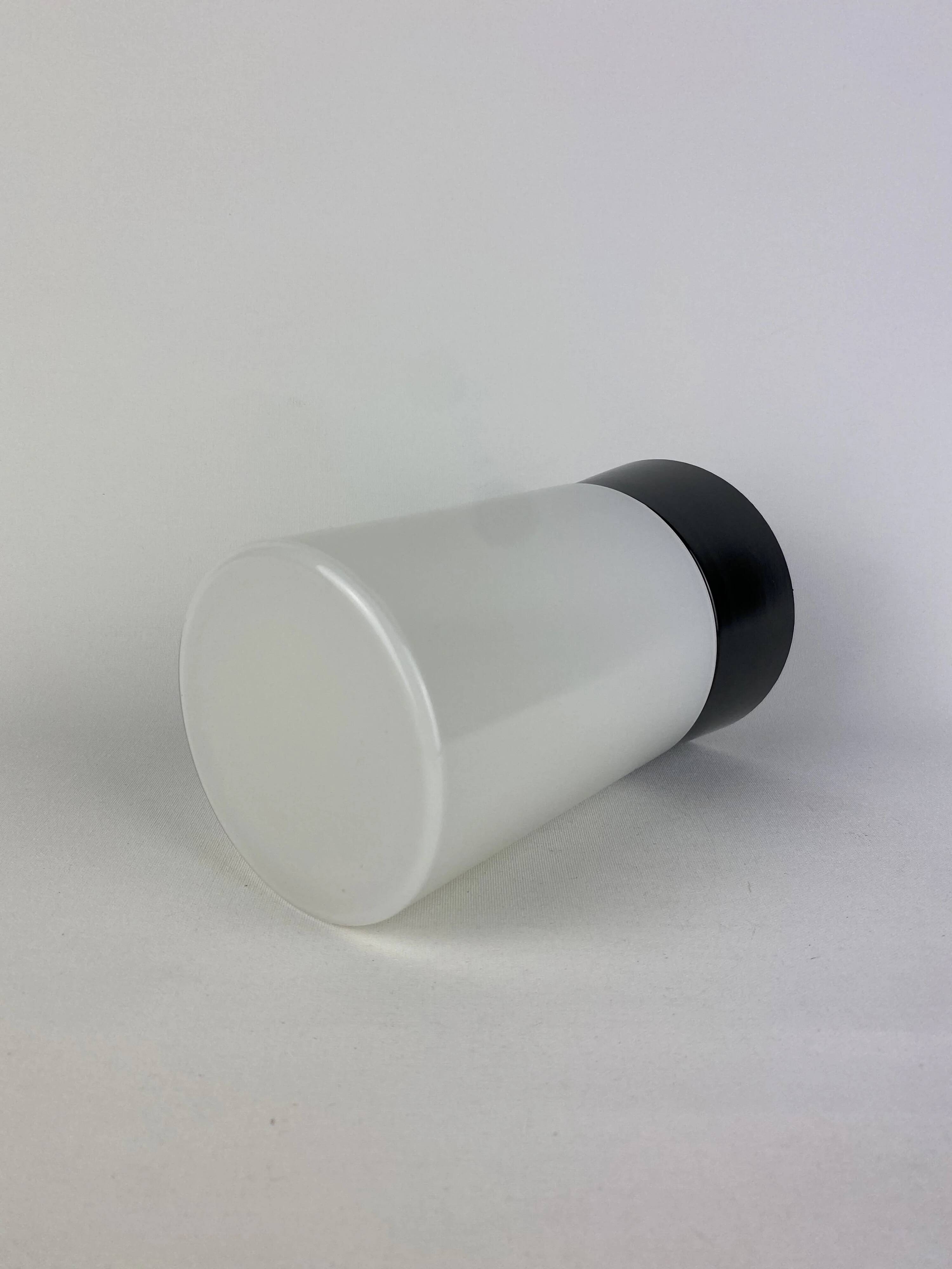 White cylindrical Art Deco chandelier RAAK with black support.
