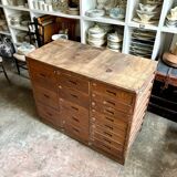Craftsman's cabinet with 16 drawers in dark wood.