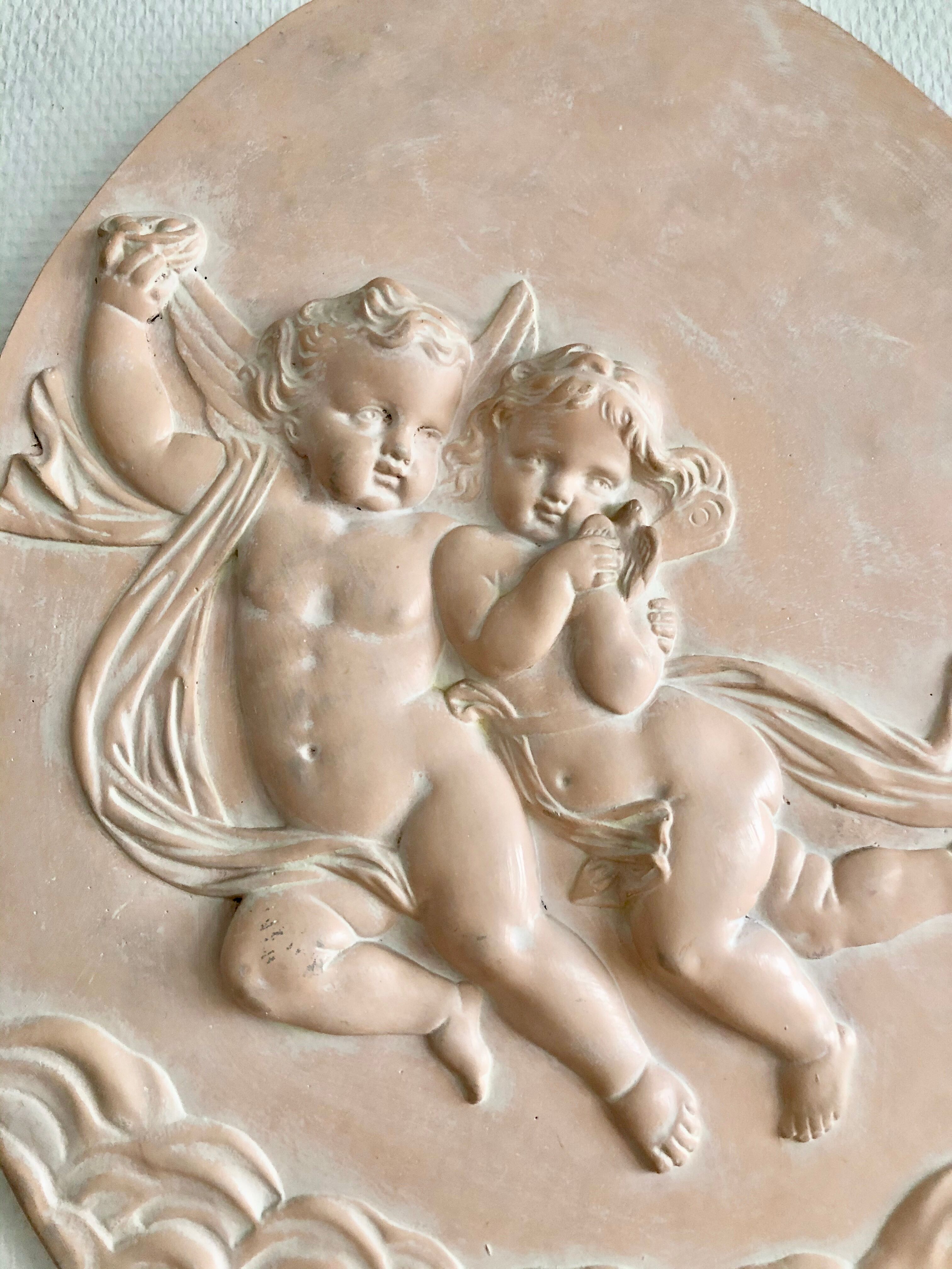 Pair of putti medallions