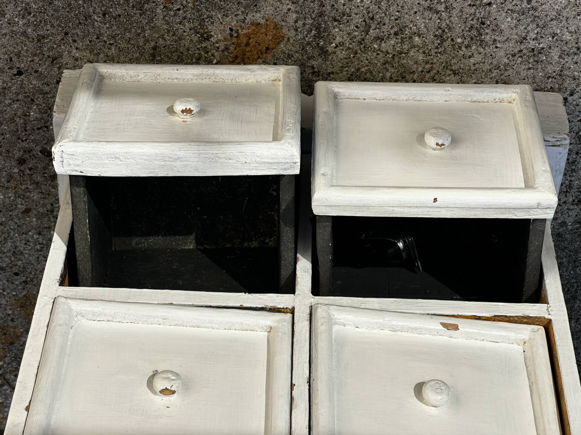Small antique workshop cabinet with 8 painted wooden drawers.
