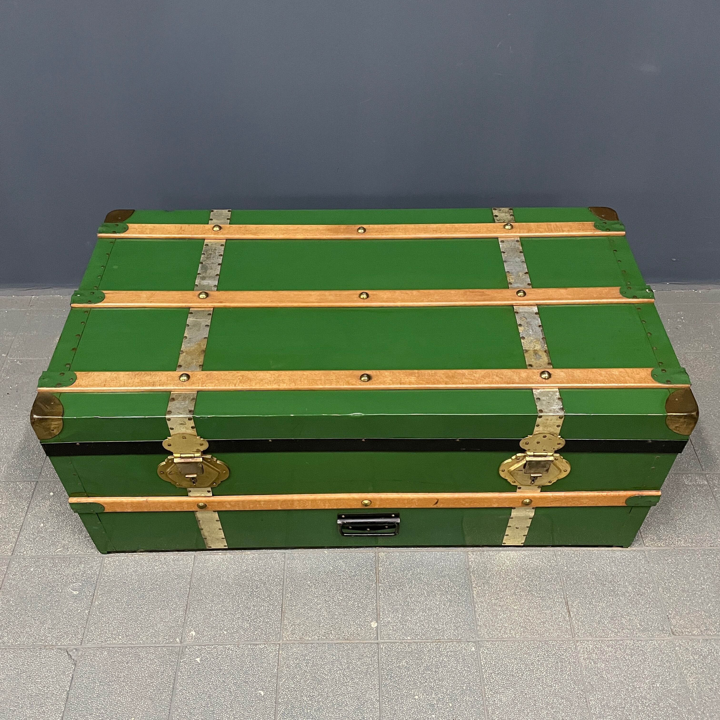 Green metal trunk with wooden sleds