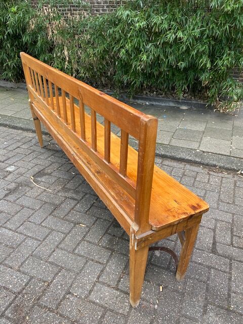 Old wooden long station bench from Belgium