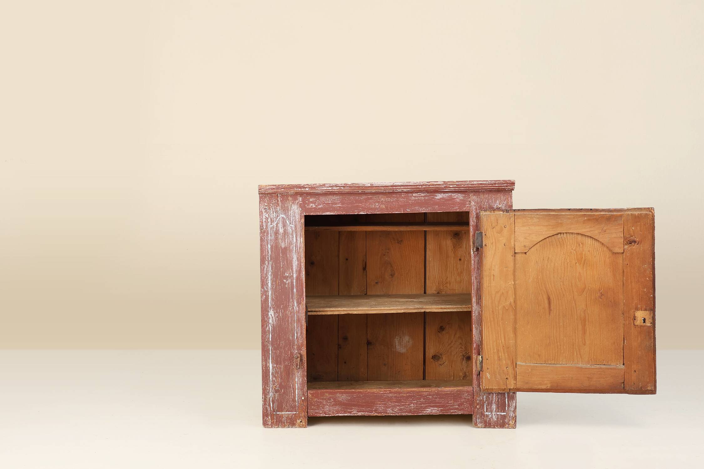 Rustic Parisian cabinet in pine wood with old burgundy paint layers, ca. 18