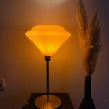 Table lamp with a vintage orange glass globe and a gold base