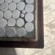 Grey ceramic mosaic top coffee table with dark wood base and brass accents, 1970s