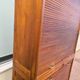 Vintage 1940s secretary desk with wooden curtains, storage, and shutters.