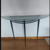 Half-moon console with glass top resting on three tapered legs in black lacquered metal ARTELANO