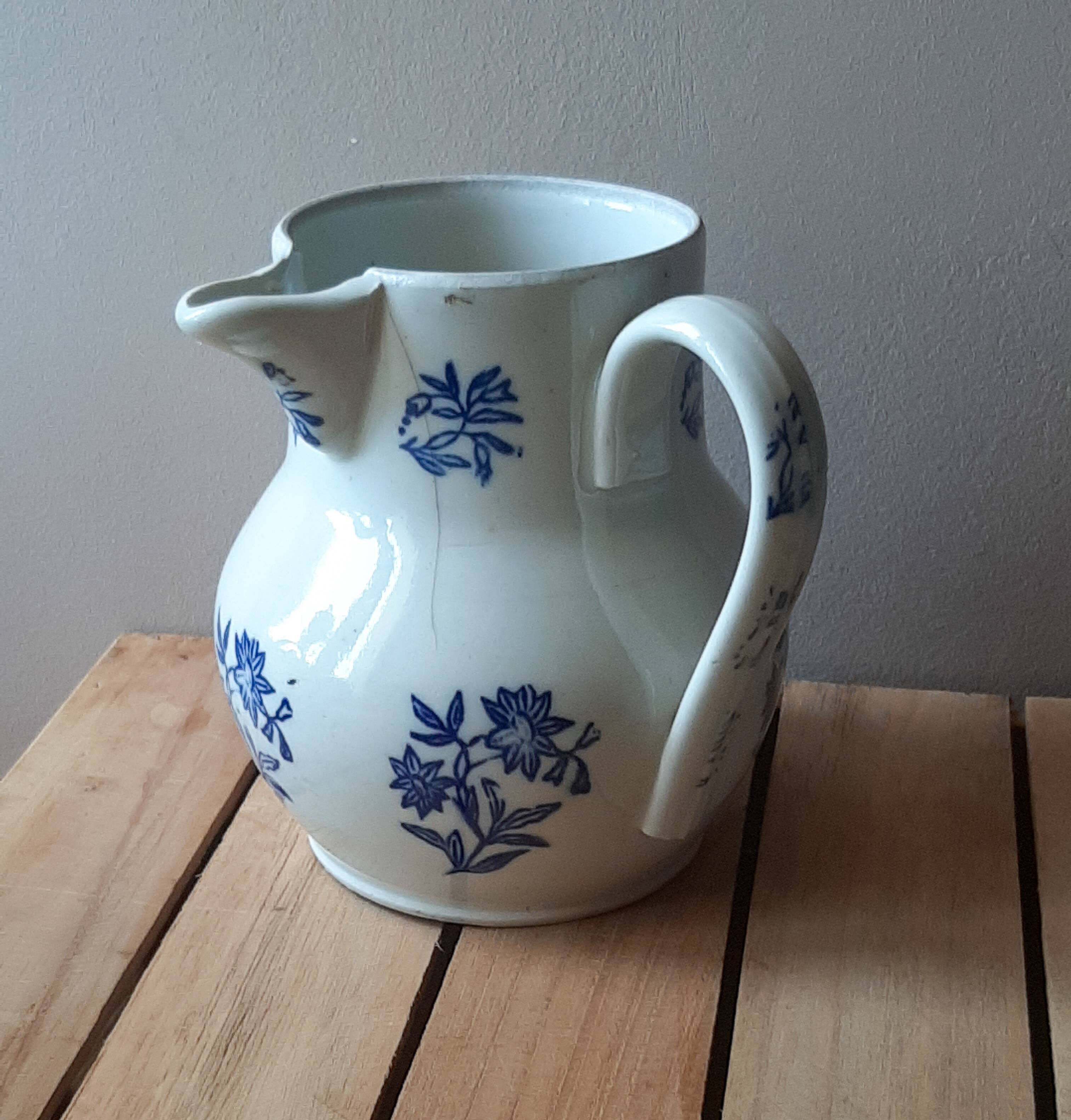 Large antique cruet in Saint Uze earthenware with blue flowers.