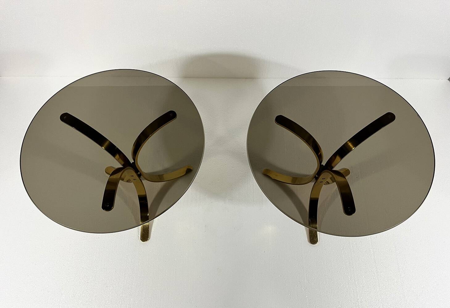 Brass and smoked glass side tables from the 1960s.