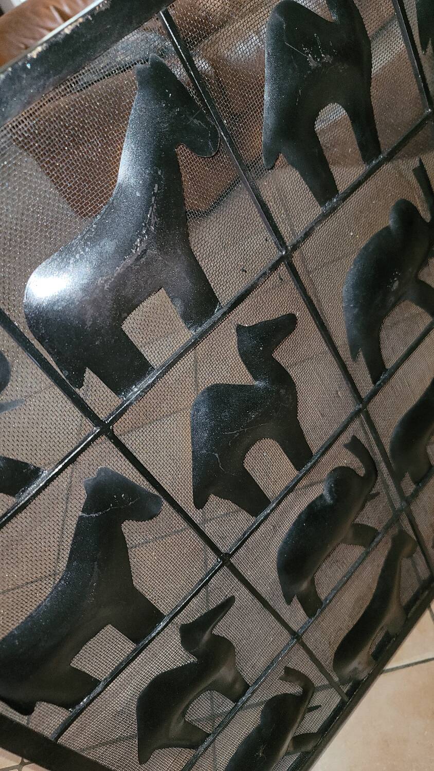 Black metal firewall decorated with animals