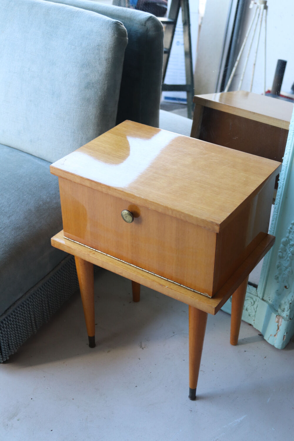 Modernist bedside table from the 1950s with compass legs.
