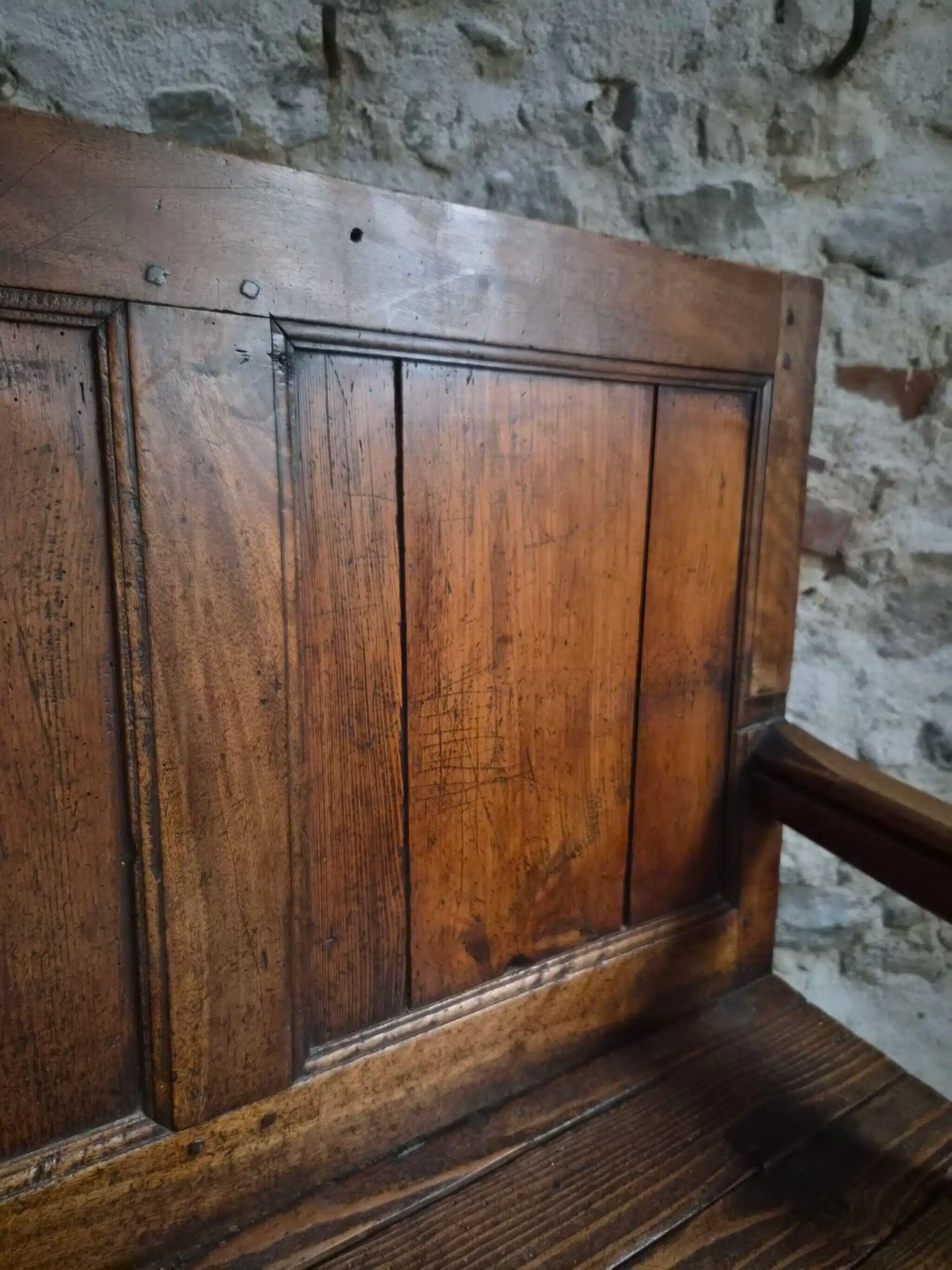 Rustic French antique storage bench from the 18th century in walnut and pine.