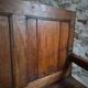 Rustic French antique storage bench from the 18th century in walnut and pine.