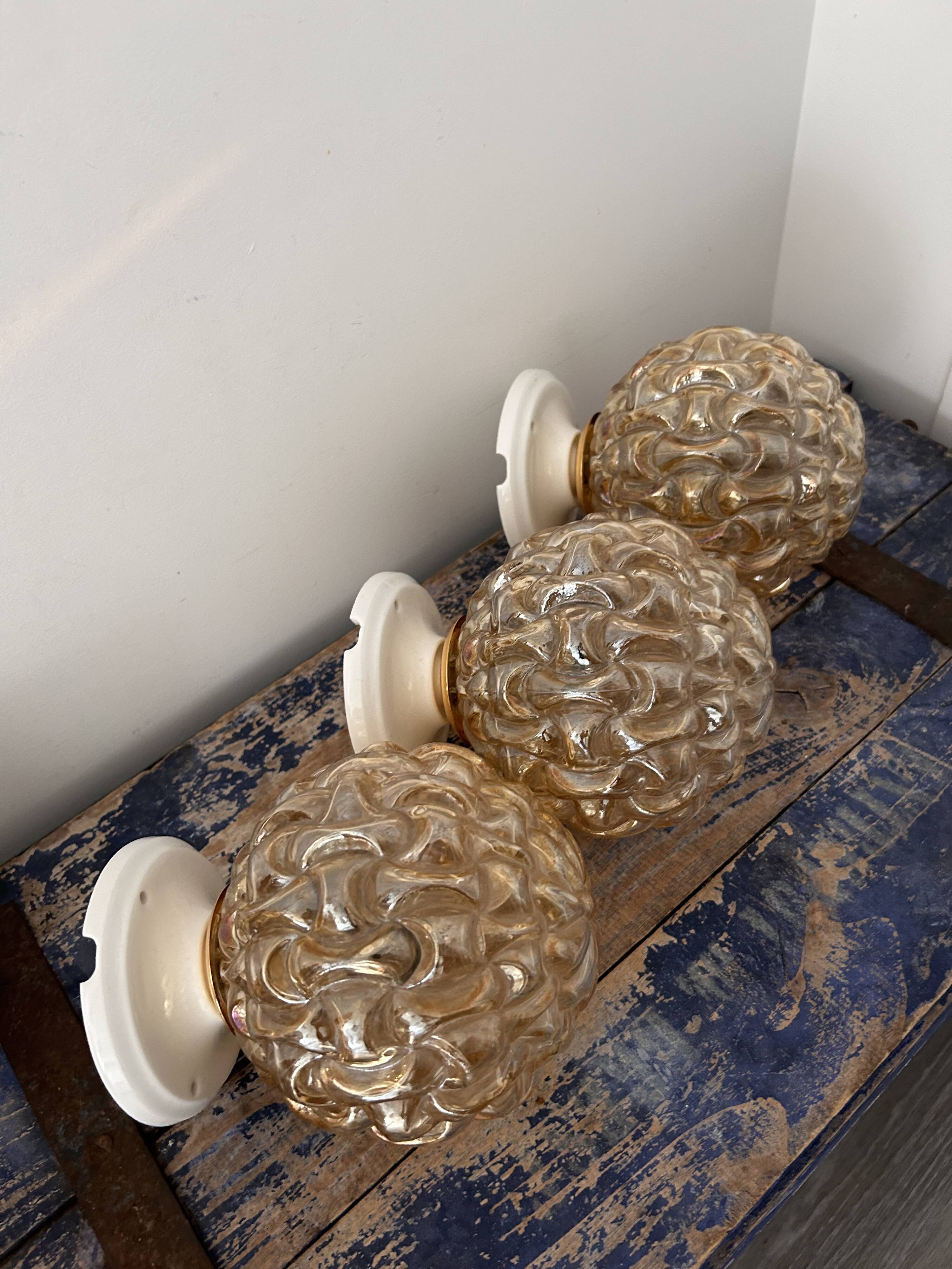Trio of golden globe wall or ceiling lights