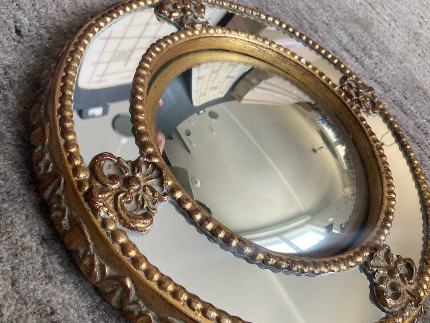 Antique domed witch's eye mirror in gilded wood