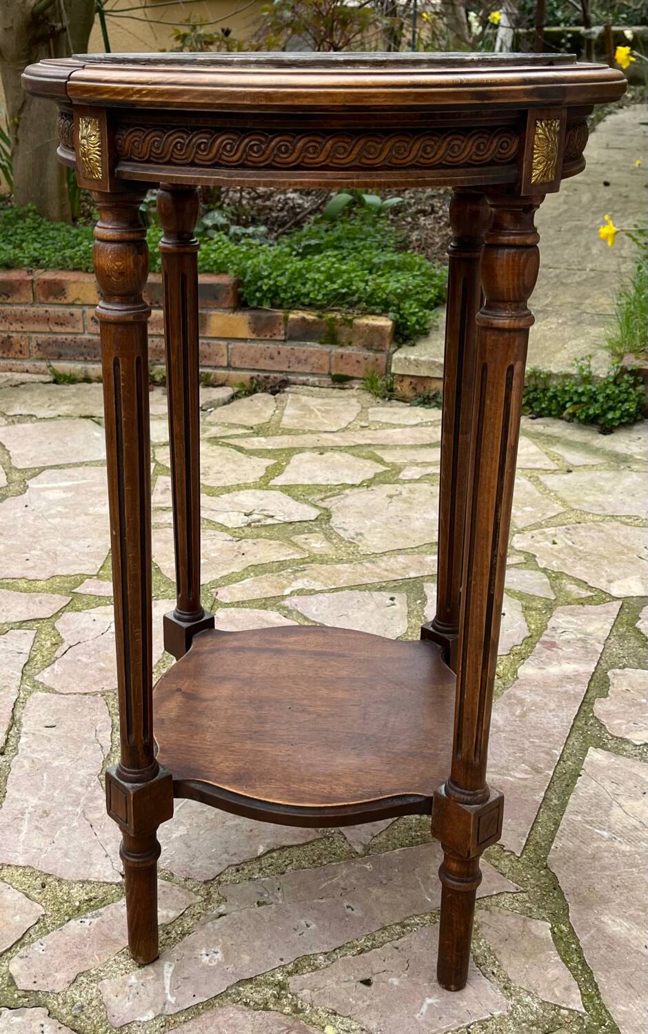 Old wooden pedestal table with marble top