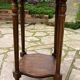 Old wooden pedestal table with marble top