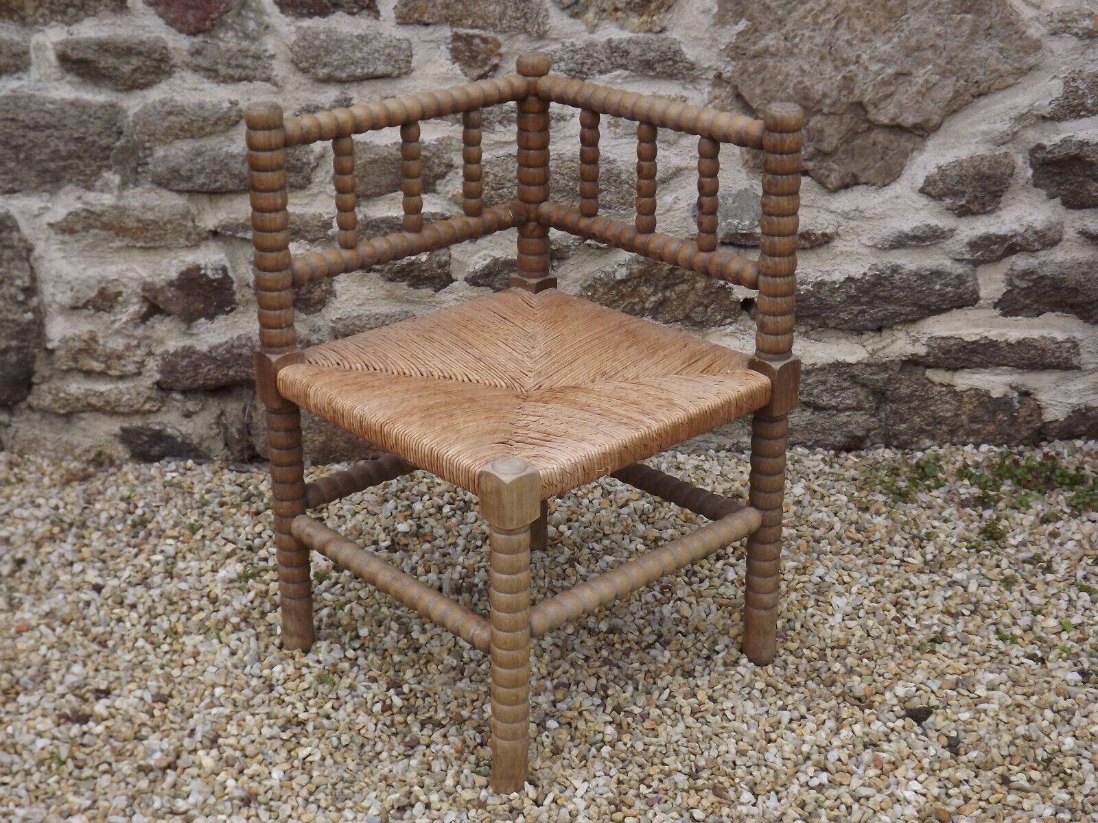 French antique turned wooden bobbin chair with rush seat
