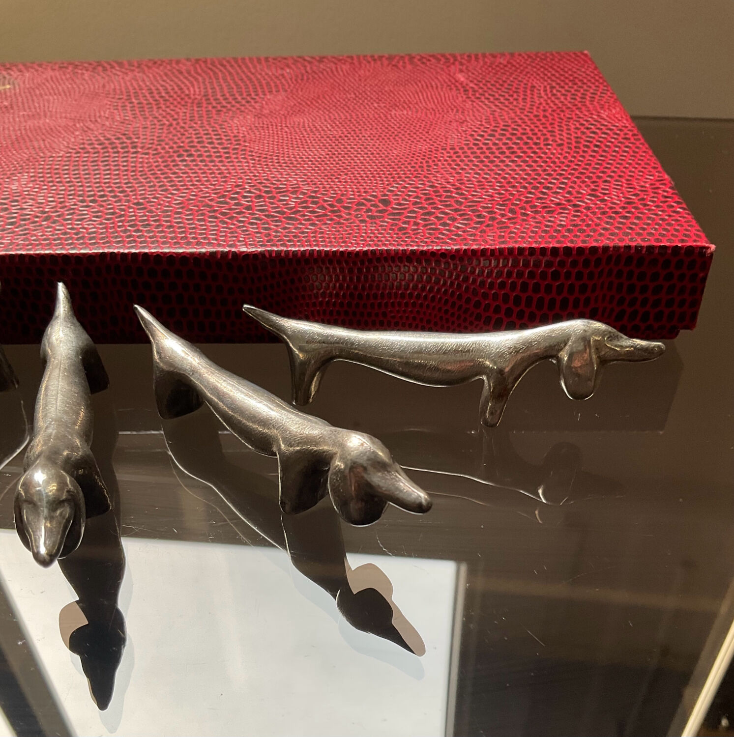 Series of vintage Dachshund knife holders in silver metal