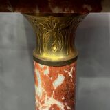 Marble pedestal decorated with gilded brass.