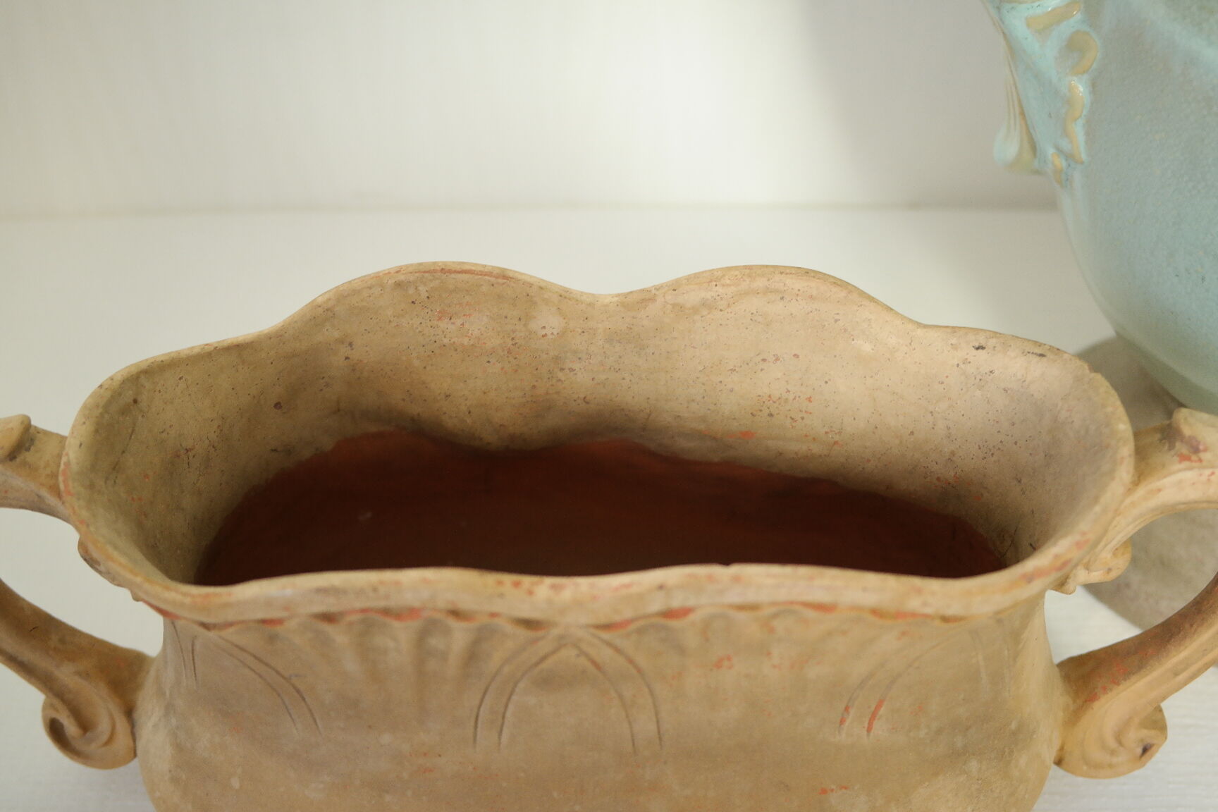 Art Nouveau jardinière with bas-reliefs in terracotta.