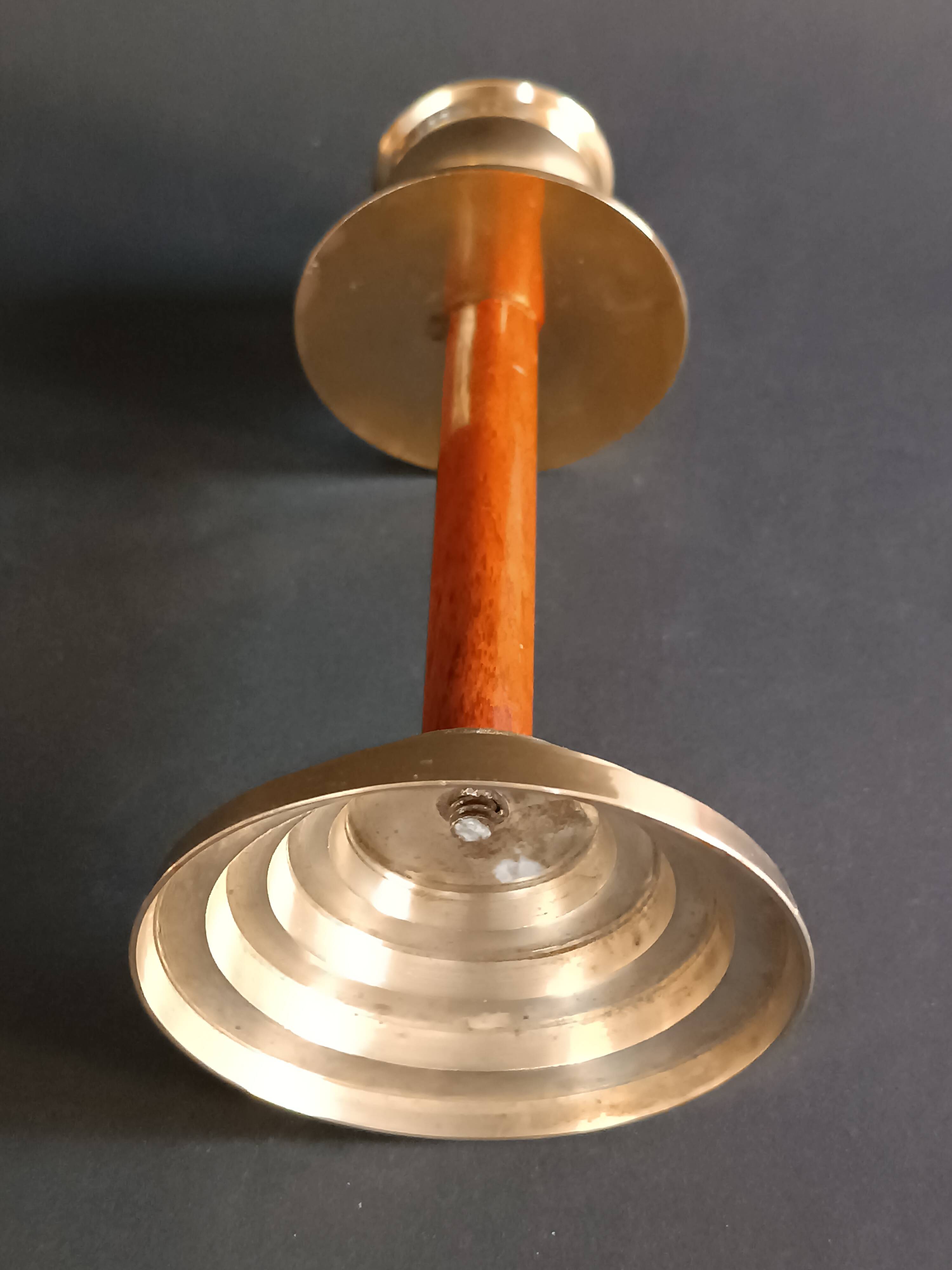 Two vintage wooden and brass candlesticks.