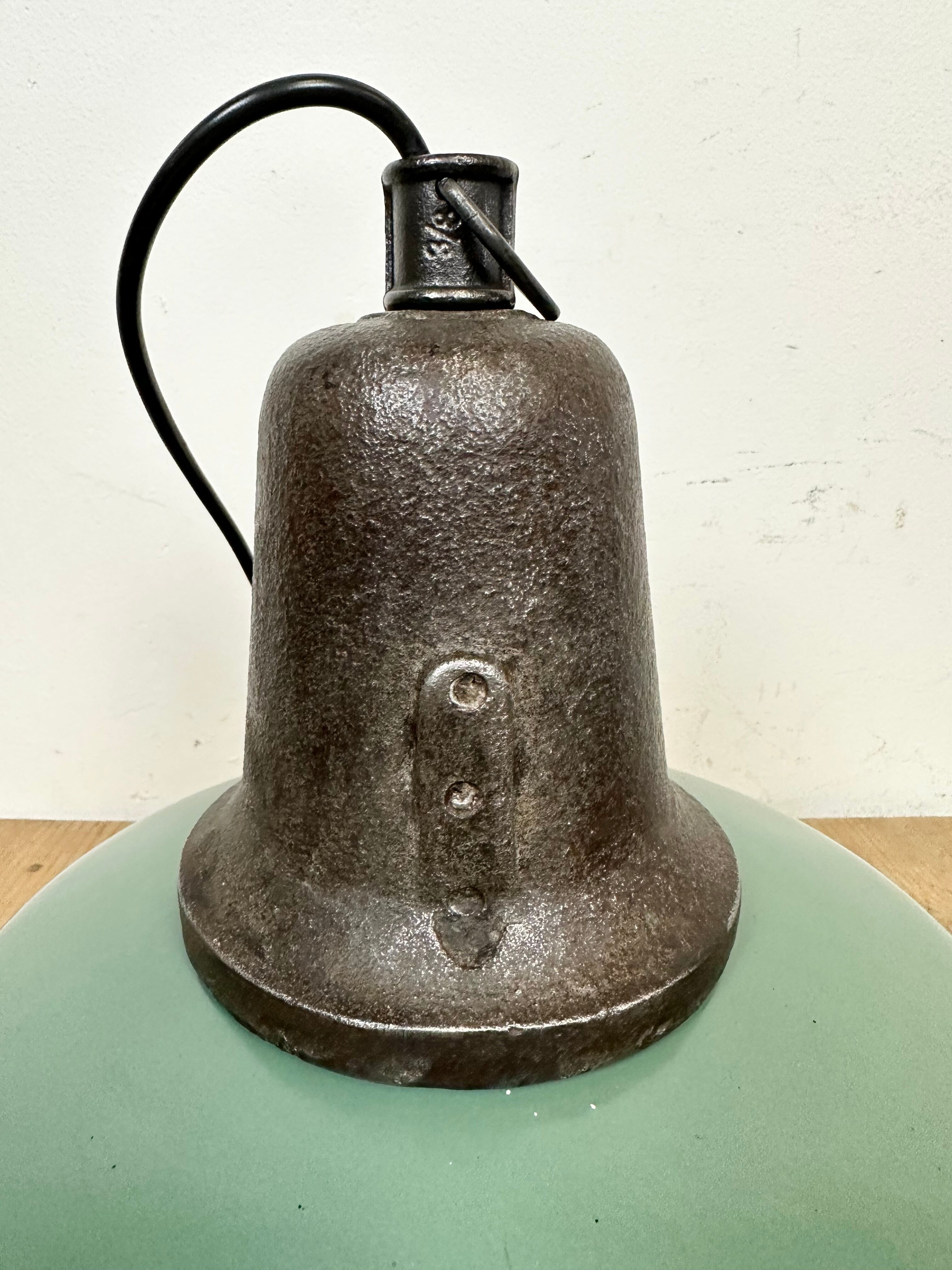 Industrial green enamel factory lamp with cast iron top, 1960s