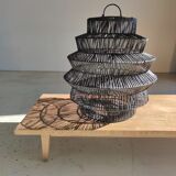 Braided rattan suspension in the shape of a black accordion