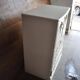 Mid-century wooden dresser painted in cream white, with 2 doors and 4 drawers, brass fittings.