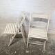 Pair of white wooden folding chairs