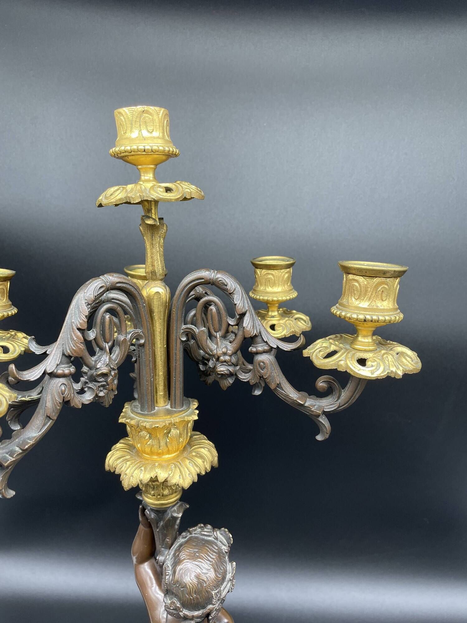Candelabra with cherub in patinated bronze