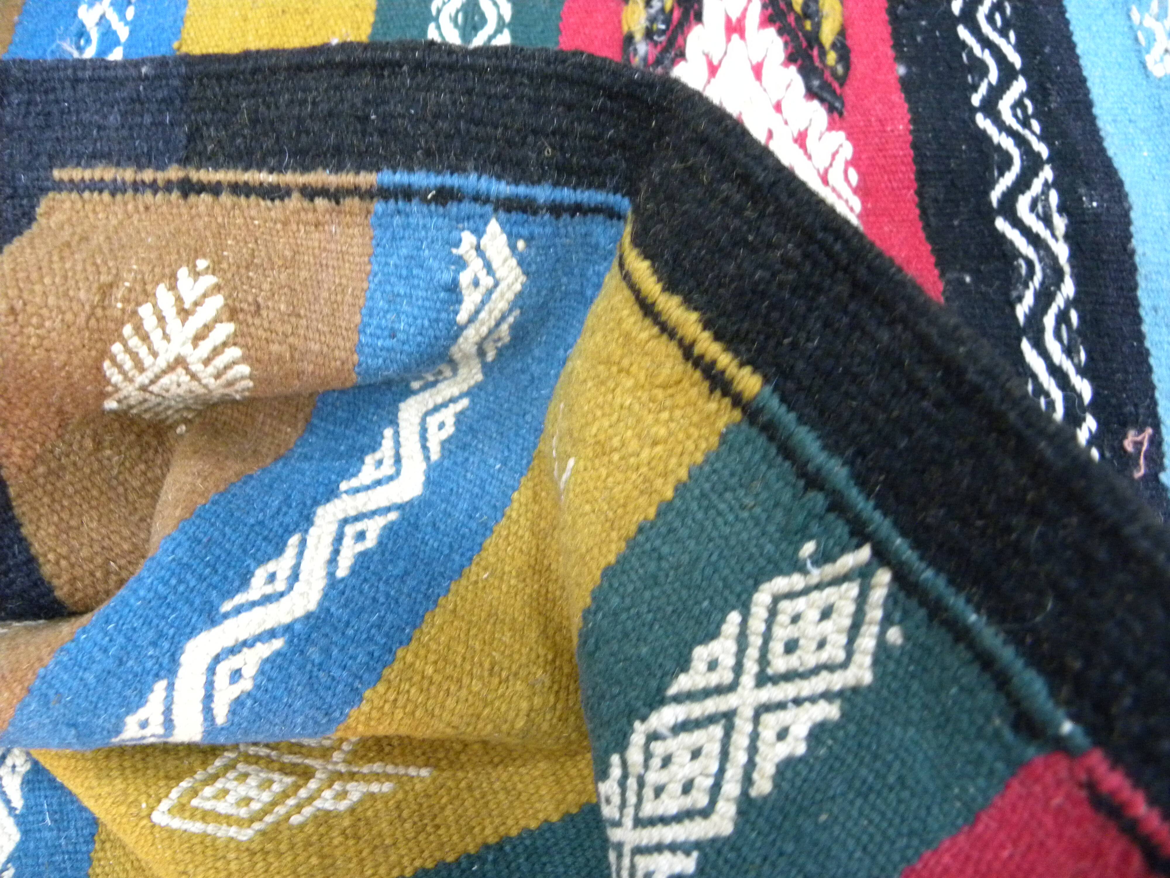 Traditional Berber tribal kilim rug with multicoloured geometric patterns.