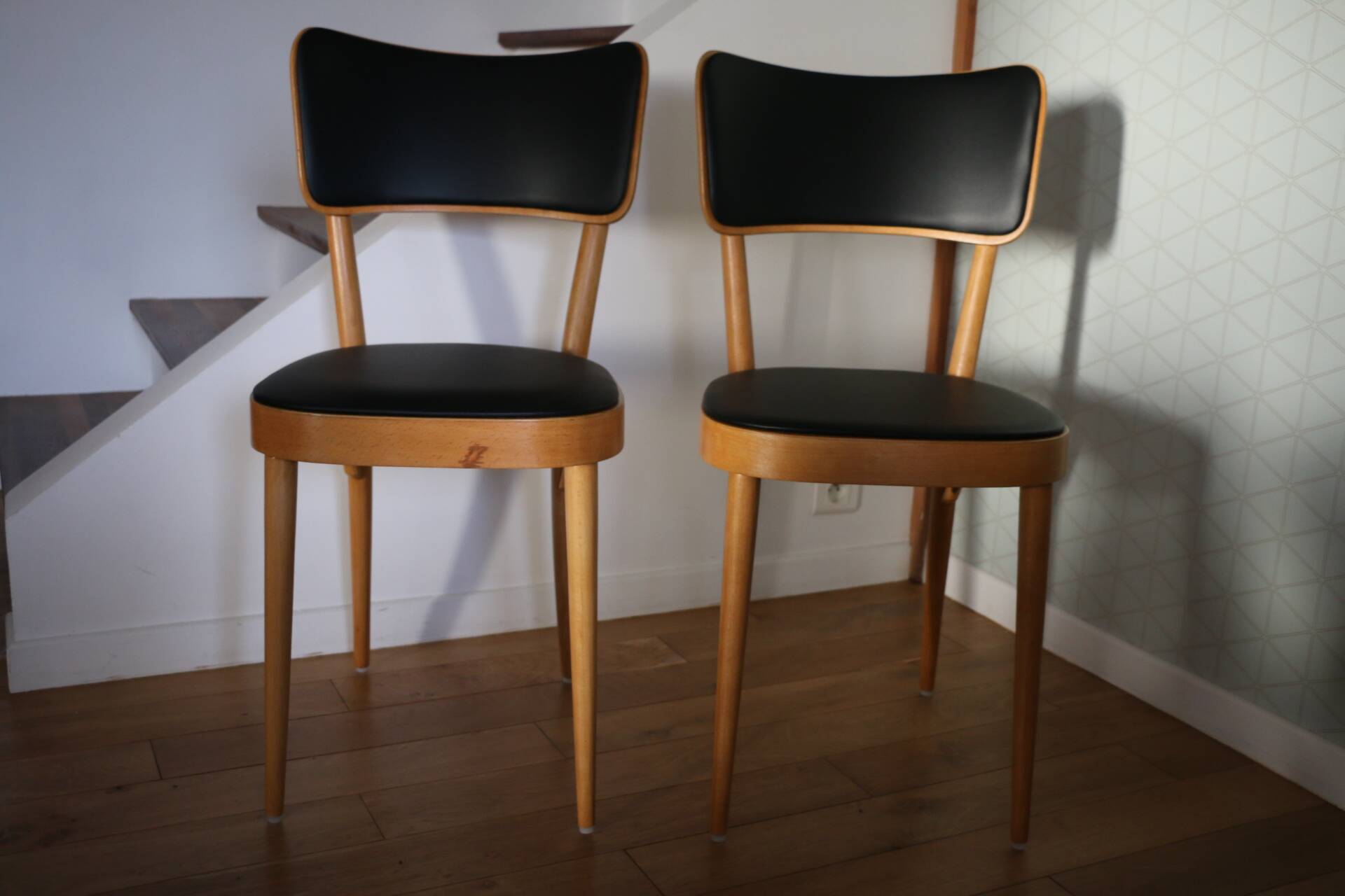 5 baumann chairs with large backs in black faux leather.