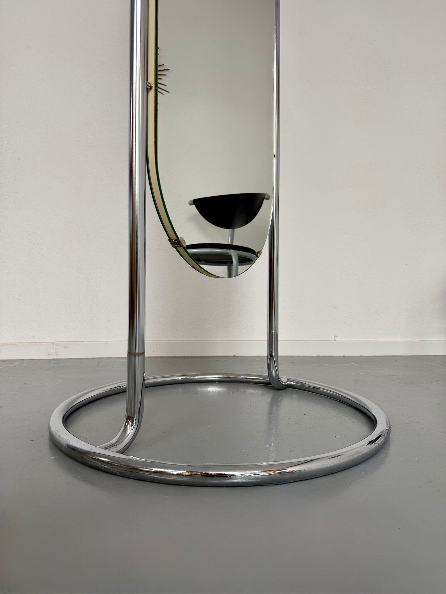 Large freestanding chrome metal full-length mirror in 1970s design.