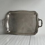 Silver metal serving tray with sculpted handles