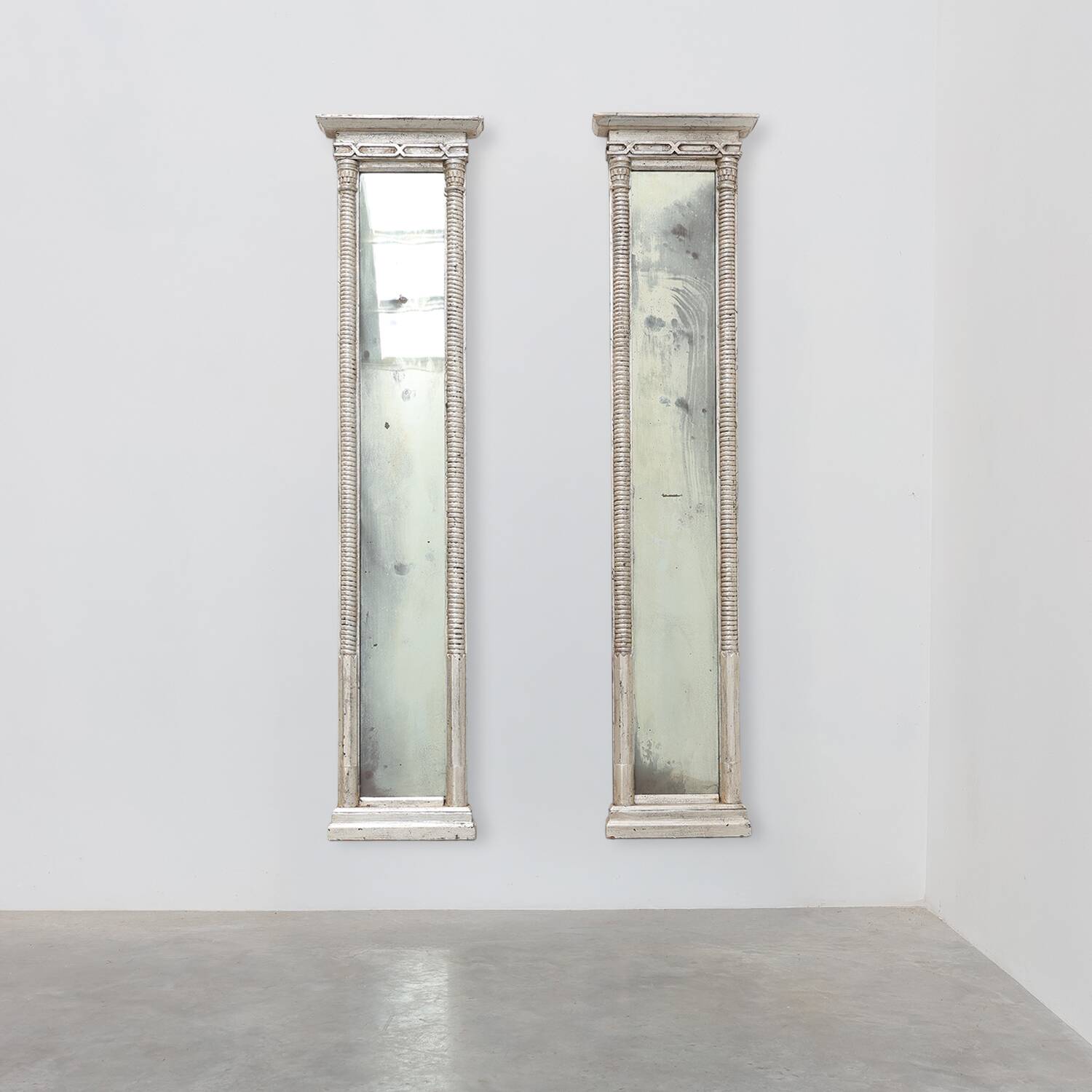 Pair of Neoclassical Silver Leaf Pier Mirrors with Ringed Columns and Corni