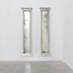 Pair of Neoclassical Silver Leaf Pier Mirrors with Ringed Columns and Corni