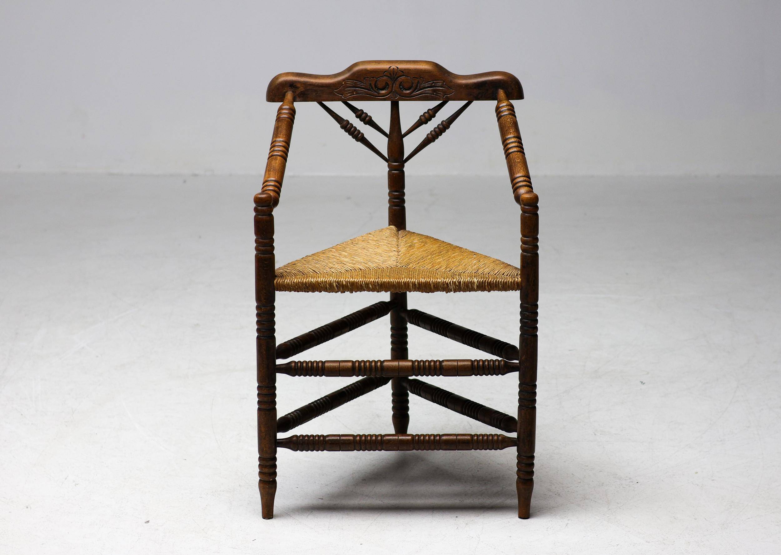 Mid Century Antiques spindle wood chaise with a rush seat.