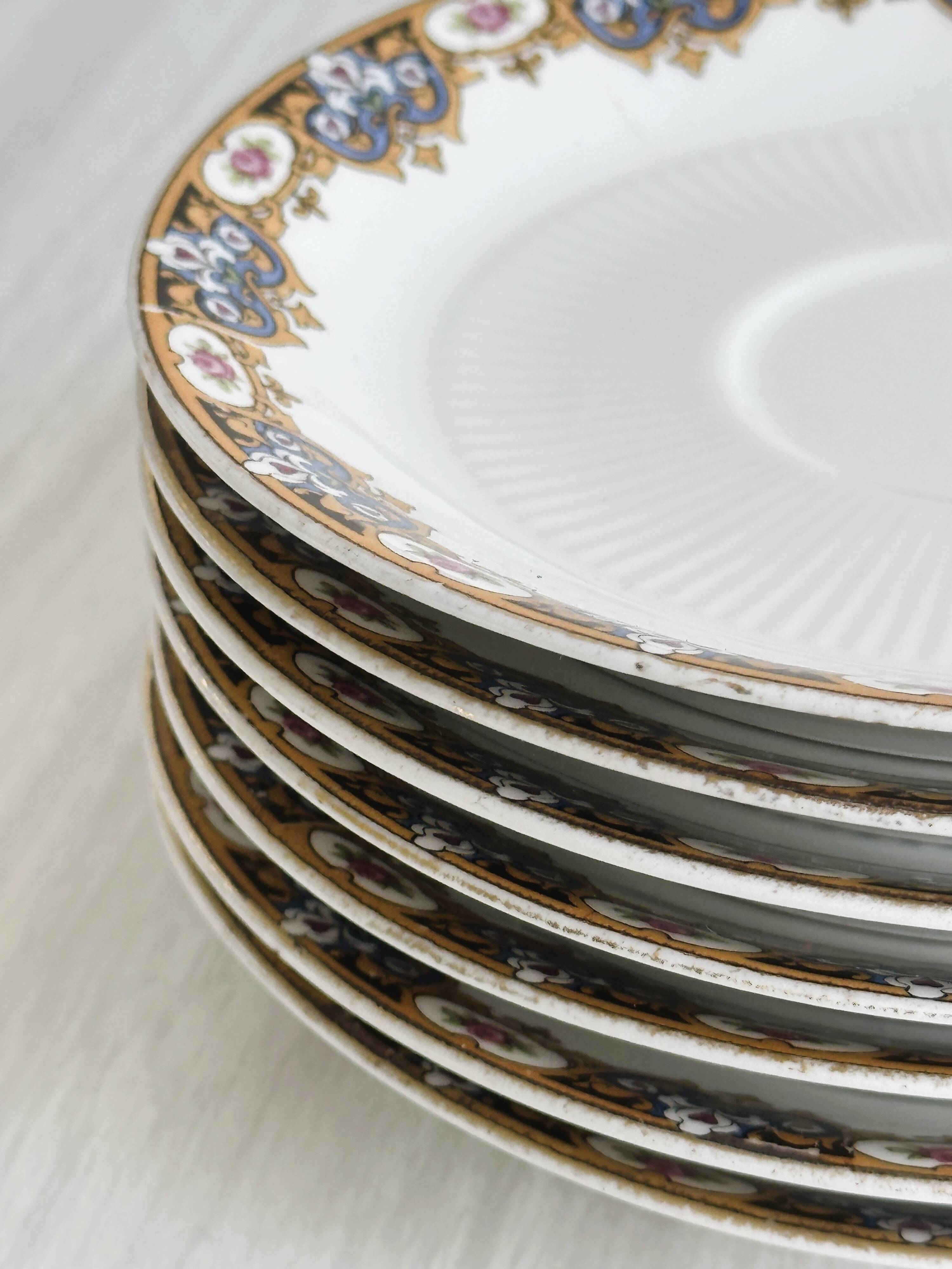 7 Limoges porcelain cups and saucers with gold decoration and floral motif.