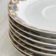 7 Limoges porcelain cups and saucers with gold decoration and floral motif.