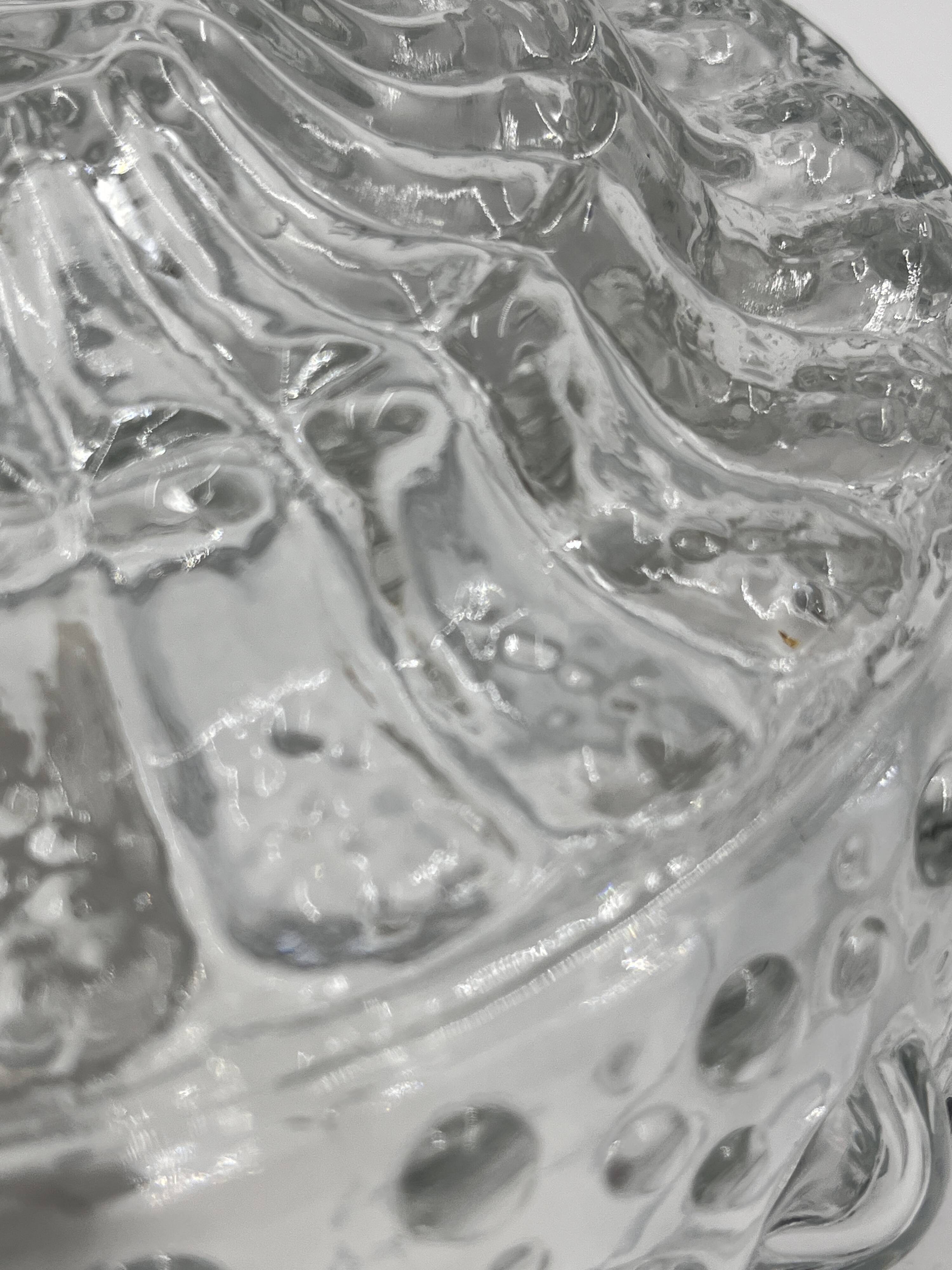 Molded glass ceiling light with spinning top relief