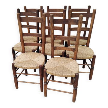 8 vintage straw chairs in the style of Charlotte Perriand.