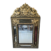 Mirror with blackened wood and embossed gold metal in the Louis XIV style,