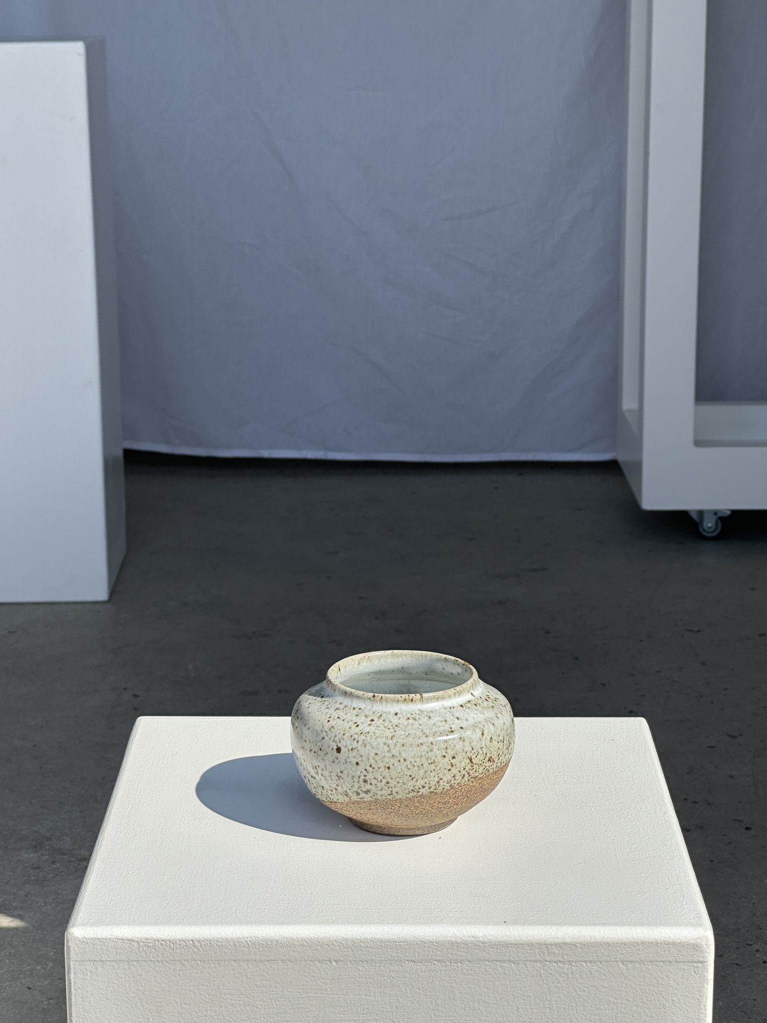 Small white ball vase tight neck in glazed speckled ceramic