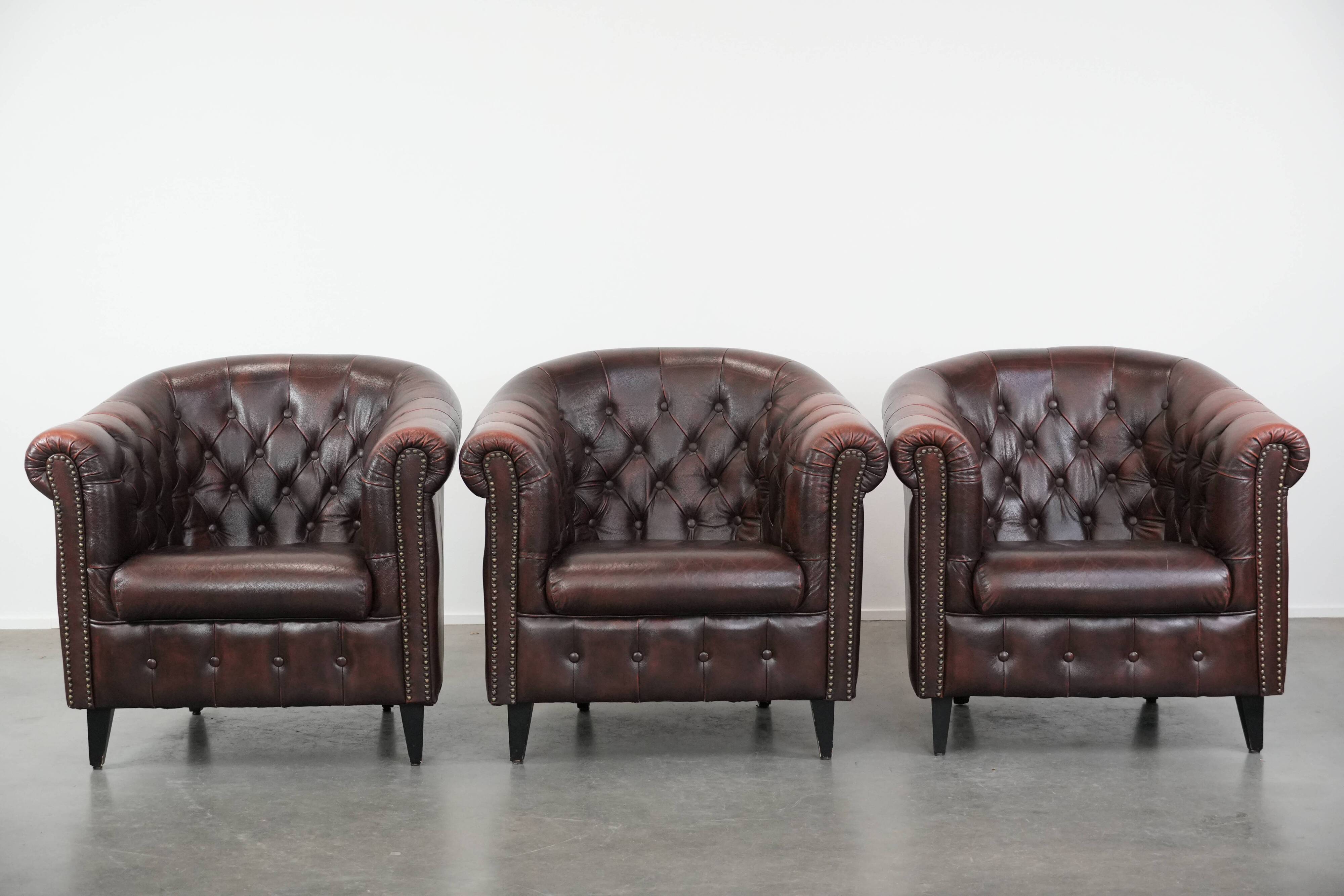 Set of three classic English-style Chesterfield cowhide  club armchairs