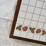 Vintage raspberry pattern earthenware and wood trivet