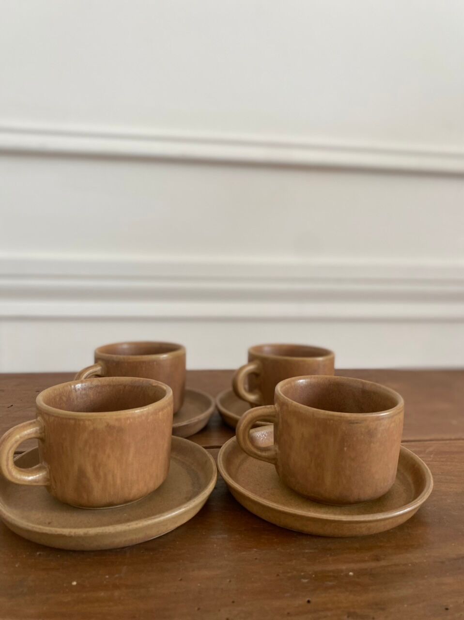 4 stoneware coffee cups and saucers